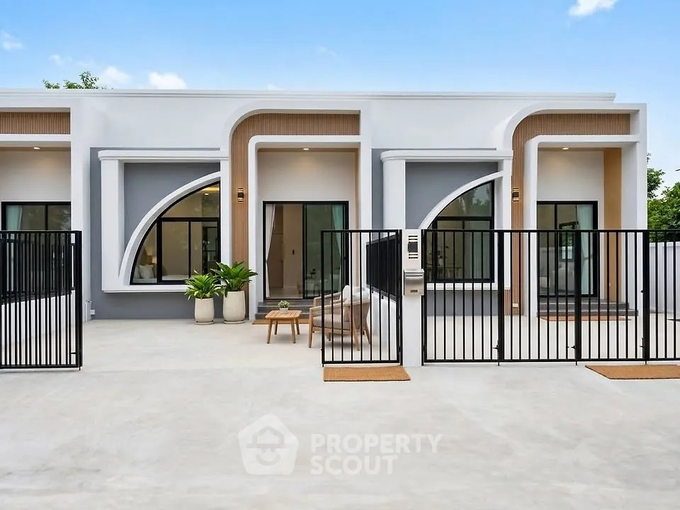 Modern single-story home with unique architectural design and gated entrance.