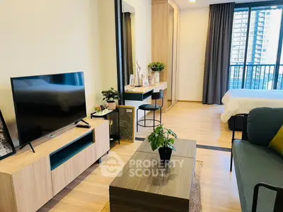 Modern open-plan living room with stylish decor and balcony view in urban apartment.