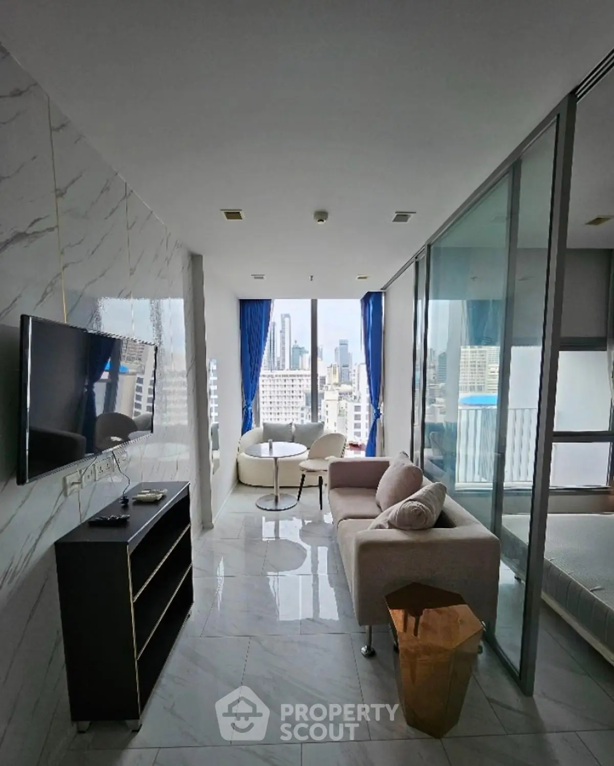 Modern high-rise apartment with stunning city view and sleek interior design.