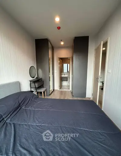 Modern bedroom with ensuite bathroom and stylish decor in a contemporary apartment.