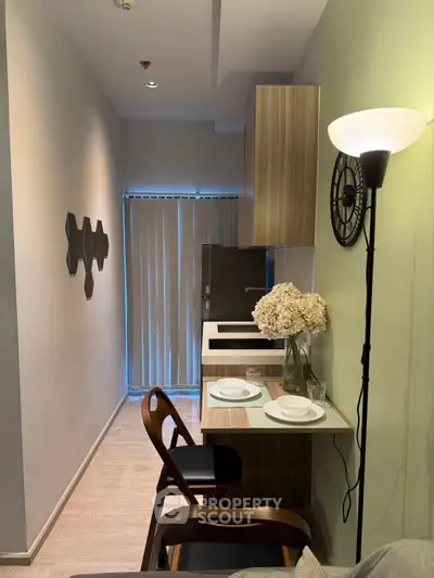 Modern compact kitchen with stylish decor and dining area in a cozy apartment setting.