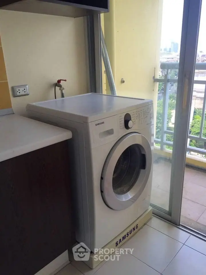 Modern apartment with Samsung washing machine and balcony view.