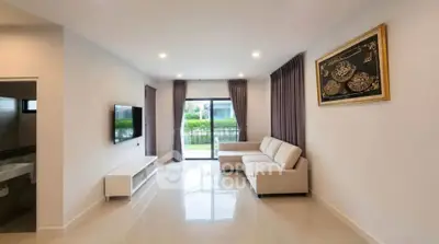 Spacious modern living room with large windows and elegant decor
