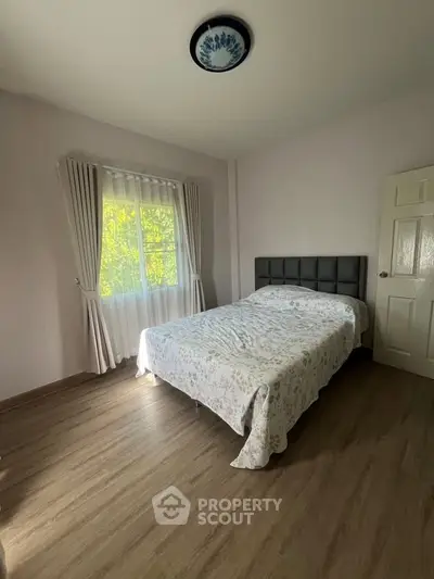 Cozy bedroom with natural light and elegant decor