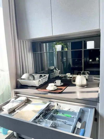 Modern kitchen with sleek cabinetry and organized cutlery drawer