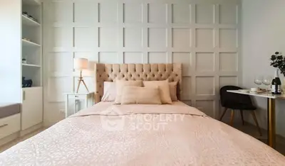 Elegant bedroom with tufted headboard and stylish decor, perfect for relaxation and comfort.