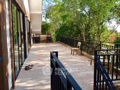 Spacious balcony with lush green views and modern railing design