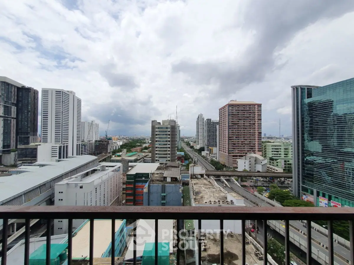Stunning urban cityscape view from high-rise balcony showcasing modern architecture.