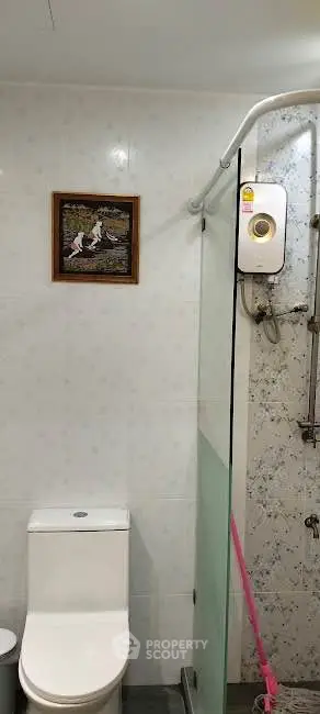 Modern bathroom with shower and toilet in a stylish real estate property.