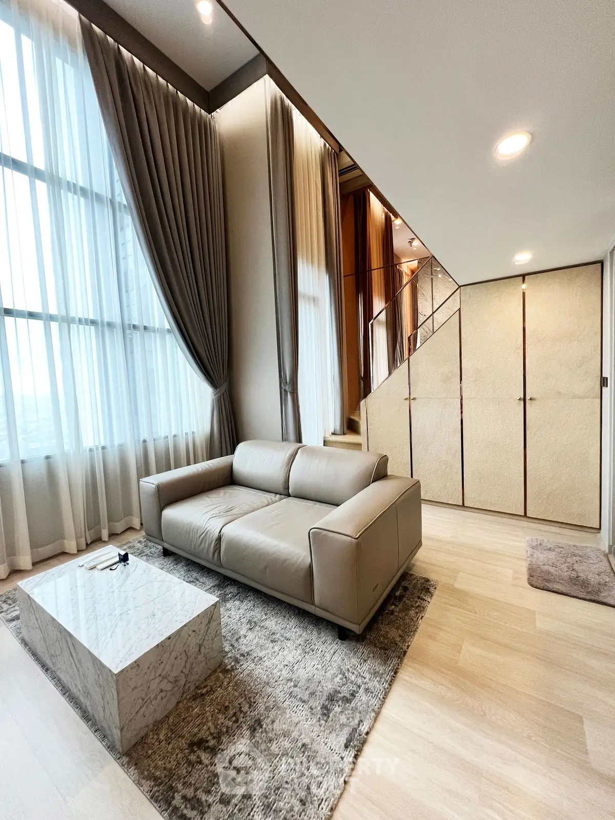 Luxurious modern living room with high ceilings and elegant decor
