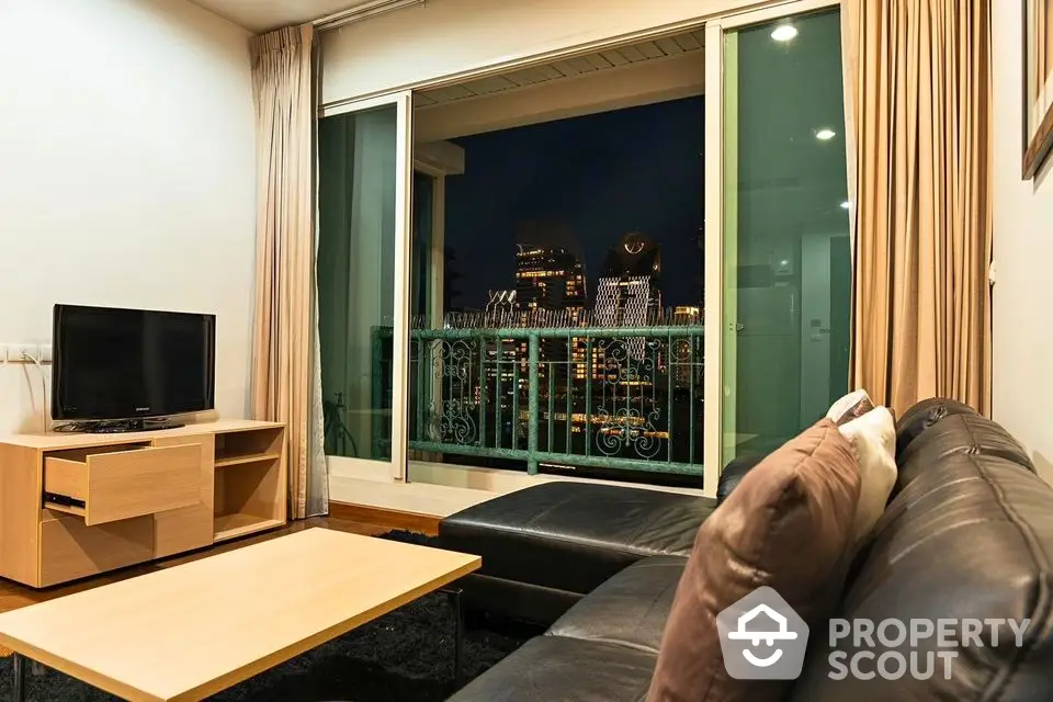 Modern living room with city view, featuring sleek furniture and large windows for natural light.