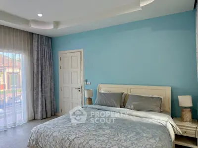 Spacious bedroom with elegant decor and natural light