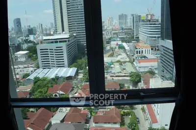 Stunning cityscape view from high-rise apartment window showcasing urban skyline.