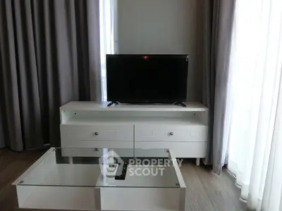 Modern living room with sleek TV stand and glass coffee table