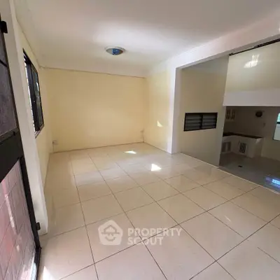 Spacious tiled living area with natural light and open layout, perfect for modern living.