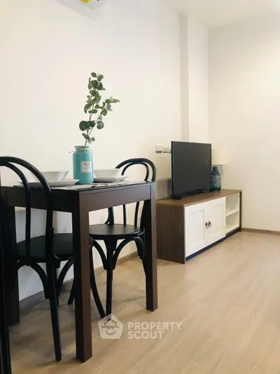 Charming living room with modern decor and cozy dining area, perfect for relaxation and entertainment.