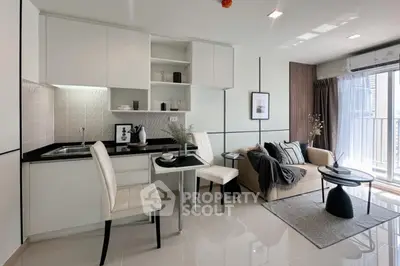 Modern open-layout living room with sleek kitchen and cozy seating area, perfect for urban living.