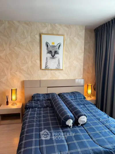 Cozy bedroom with stylish decor and modern lighting, featuring a unique fox artwork above the bed.