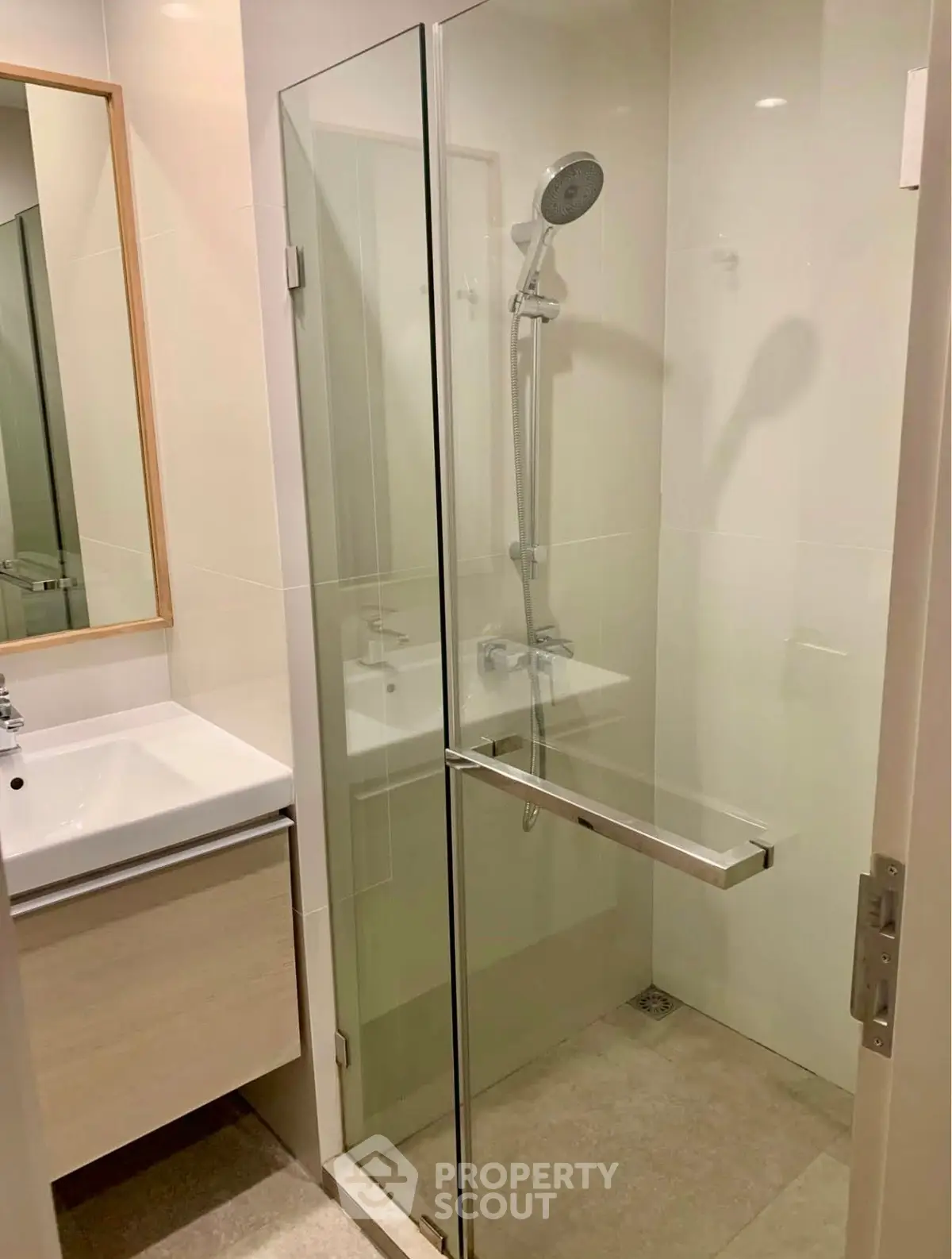 Modern bathroom with glass shower enclosure and sleek vanity unit