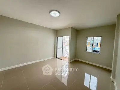 Spacious unfurnished room with tiled flooring and natural light, ideal for customization.