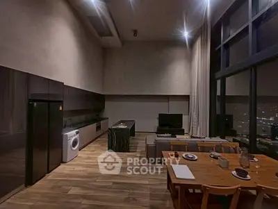 Spacious modern living room with open kitchen and city view