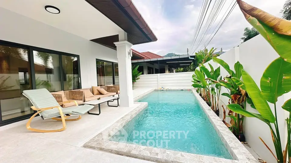 Luxurious modern home with private pool and stylish outdoor seating area.