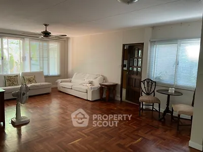 Spacious living room with wooden flooring and cozy seating area
