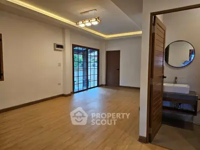 Spacious modern living room with wooden flooring and stylish lighting