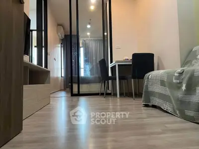 Modern apartment interior with sleek flooring and stylish furniture, featuring a cozy dining area and mirrored closet.