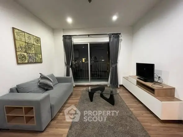 Modern living room with sleek furniture and balcony view