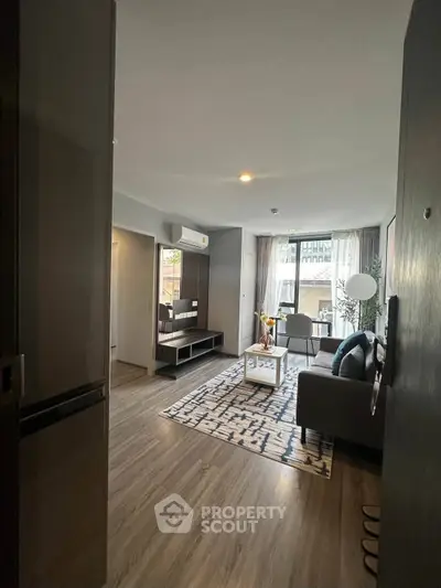 Modern living room with stylish decor and natural light in a contemporary apartment.