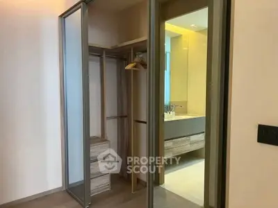 Modern apartment with sleek closet and bathroom view