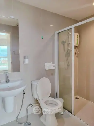 Modern bathroom with shower and sleek fixtures in a contemporary home.