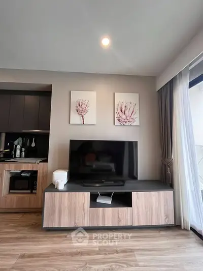 Modern living room with stylish TV stand and floral wall art, featuring sleek wood flooring and natural light.