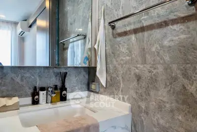 Modern bathroom with marble walls and sleek sink design