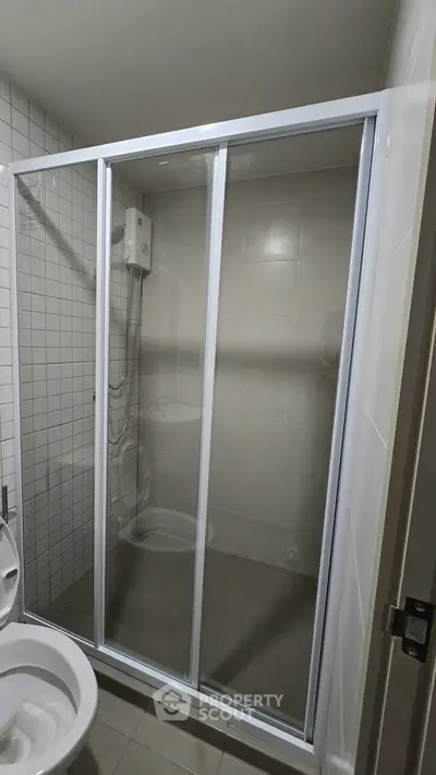 Modern bathroom with glass shower enclosure and tiled walls