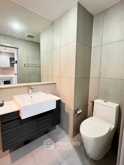 Modern bathroom with sleek fixtures and contemporary design in a stylish apartment.
