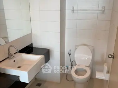 Modern bathroom with sleek white tiles and contemporary fixtures