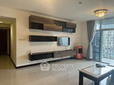 Modern living room with sleek wall-mounted storage and large windows opening to a balcony.