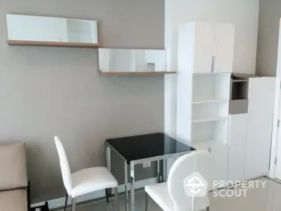 Modern minimalist study area with sleek furniture and ample storage space.