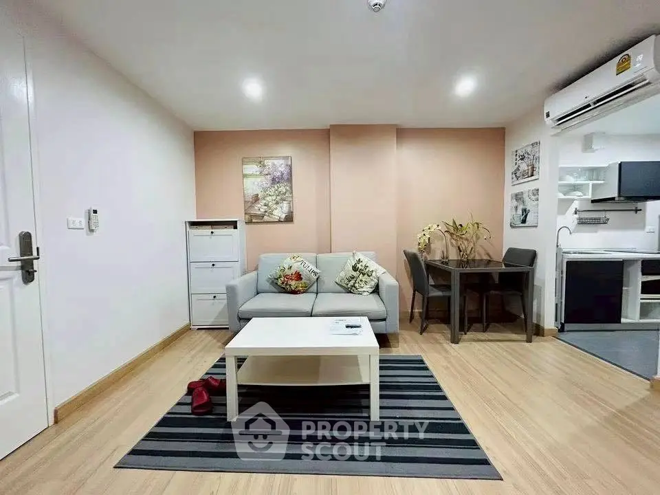 Modern living room with cozy sofa, dining area, and stylish decor in open-plan apartment.