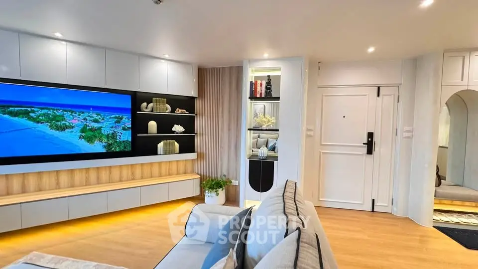 Modern living room with sleek design, large TV, and stylish shelving, perfect for contemporary living.
