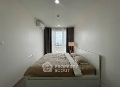 Modern bedroom with city view, featuring minimalist design and natural light.