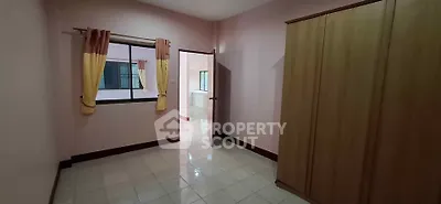 Spacious bedroom with wardrobe and window in cozy apartment