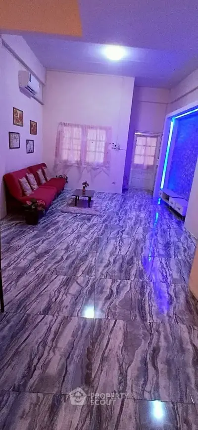 Spacious living room with modern marble flooring and ambient lighting