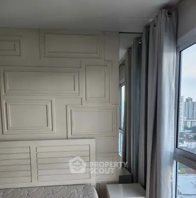 Modern bedroom with stylish wall paneling and city view from large windows.