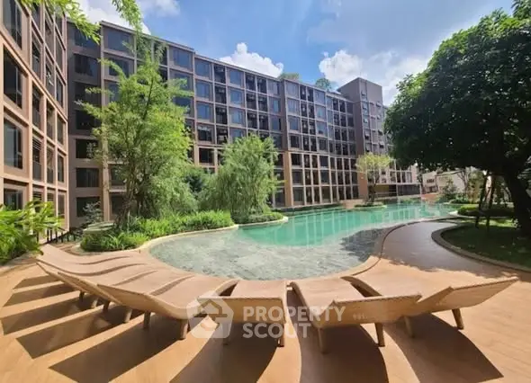 Luxurious apartment complex with stunning pool and lush greenery, perfect for relaxation and leisure.
