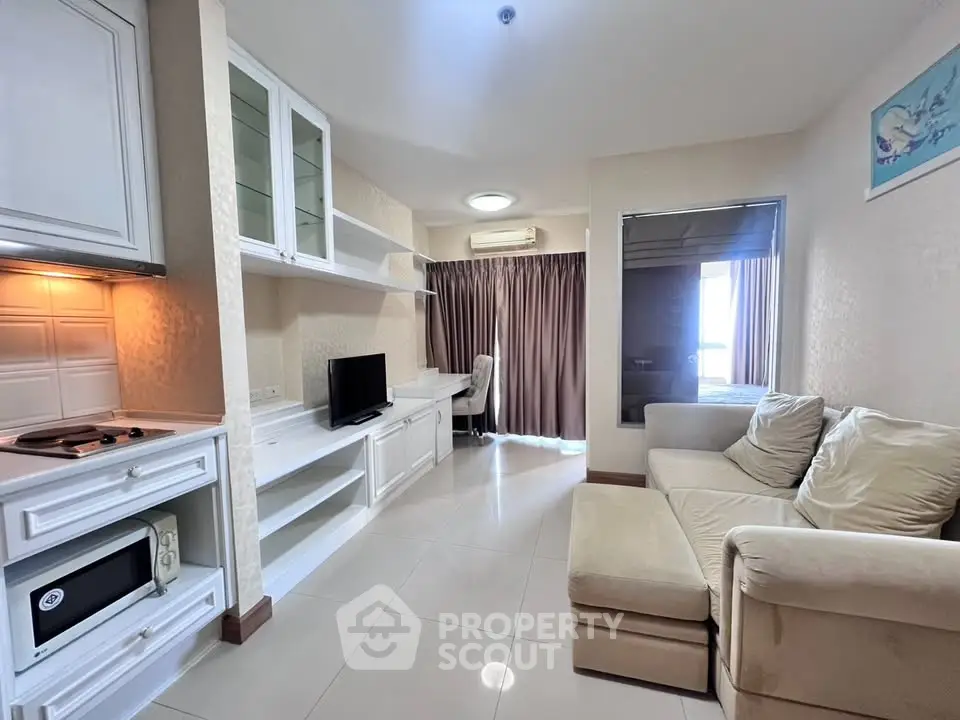 Cozy living room with modern furniture and built-in storage in a stylish apartment.