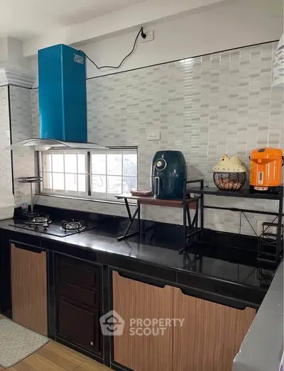 Modern kitchen with sleek black countertops and stylish appliances