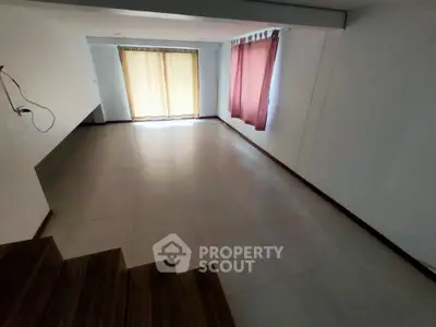 Spacious empty room with large windows and tiled flooring, ideal for customization.